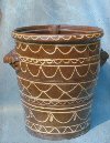 Large storage vessel, brown glaze, yellow slip-trailing