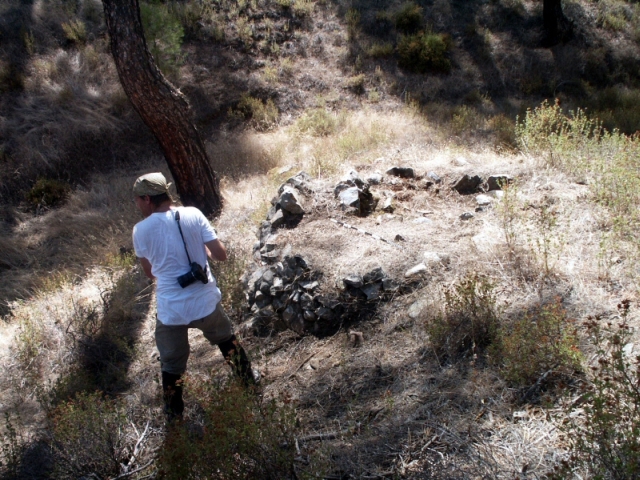 Figure 38: Pitch kiln (TP105) in the Rotson Valley, with photographer Chris Parks. Photograph: Michael Given.