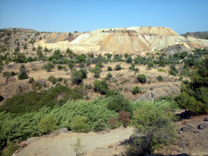 Figure 55: Mavrovouni from the north-west, with Memi mine in the background, the Rock of Ayios Kyriakos on the right, and the slag heap visible as a long rubble pile just over halfway up on the left. Photograph: Chris Parks. 