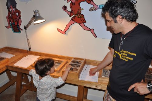 Parent watching child in a hands-on exhibit