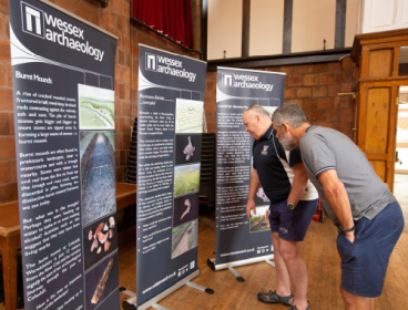 Photo of 2 people bending forward to read information displays